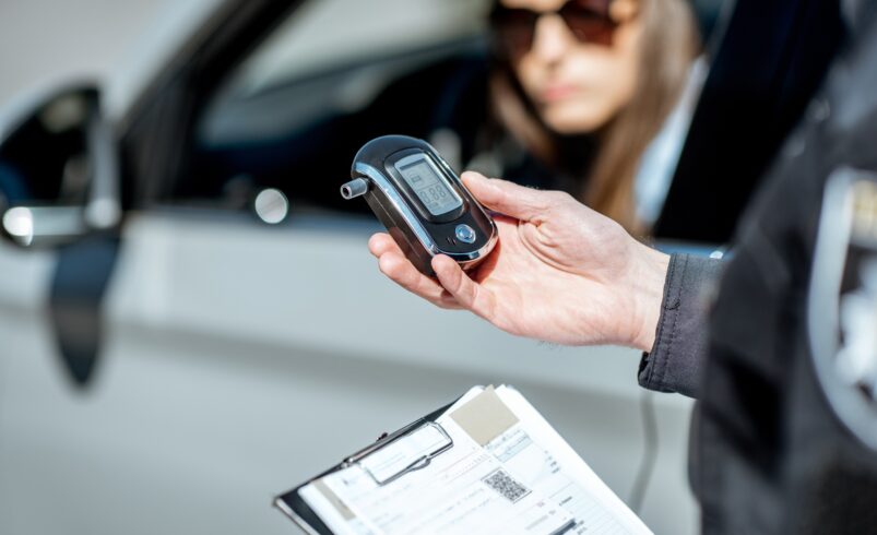 Policeman with alcotest device